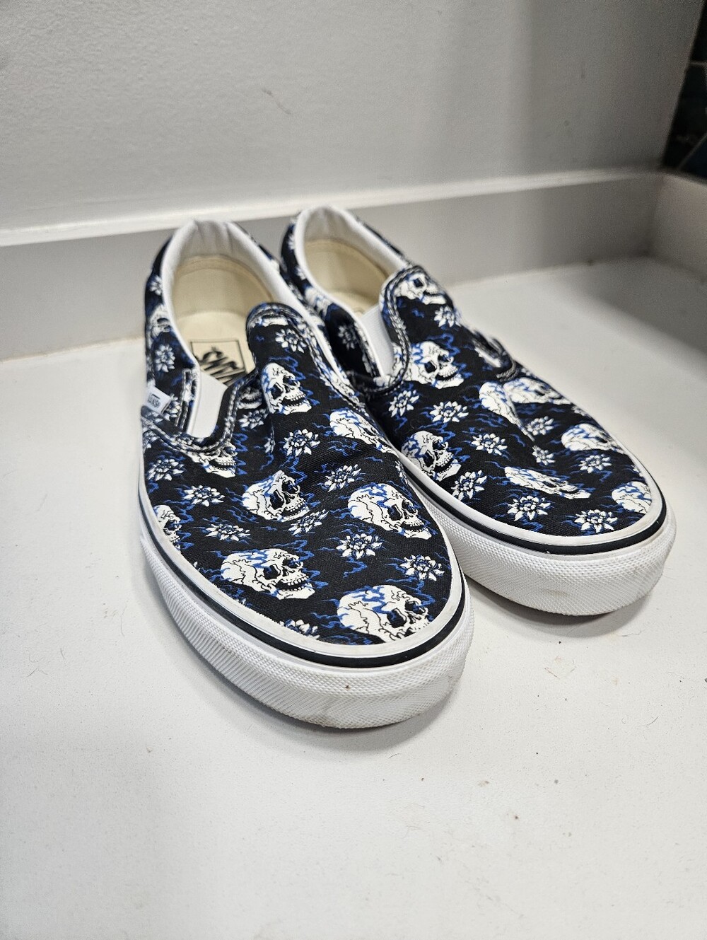 Vans Slip-On Sneakers in Navy with White Skull Print